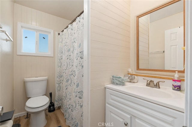 bathroom featuring vanity, curtained shower, wood-type flooring, and toilet