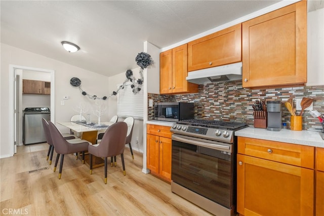 kitchen with tasteful backsplash, light hardwood / wood-style floors, gas stove, and stove