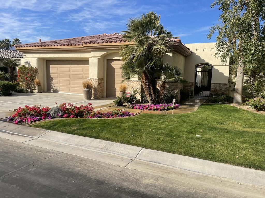 view of front of house with a garage and a front lawn