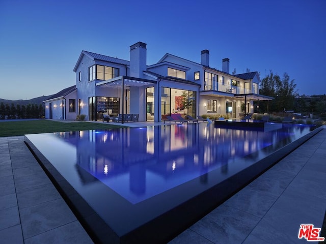 view of pool at dusk