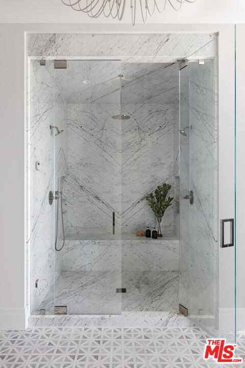 bathroom featuring a shower with shower door