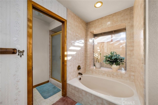 bathroom featuring tile patterned floors and separate shower and tub