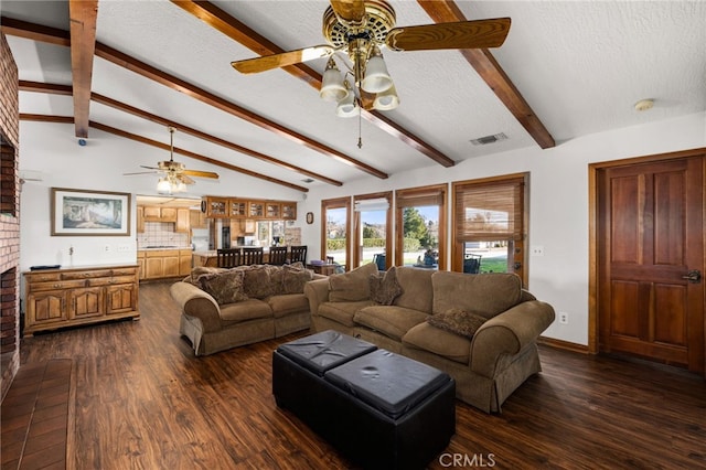 living room with vaulted ceiling with beams, dark wood-type flooring, a textured ceiling, and ceiling fan