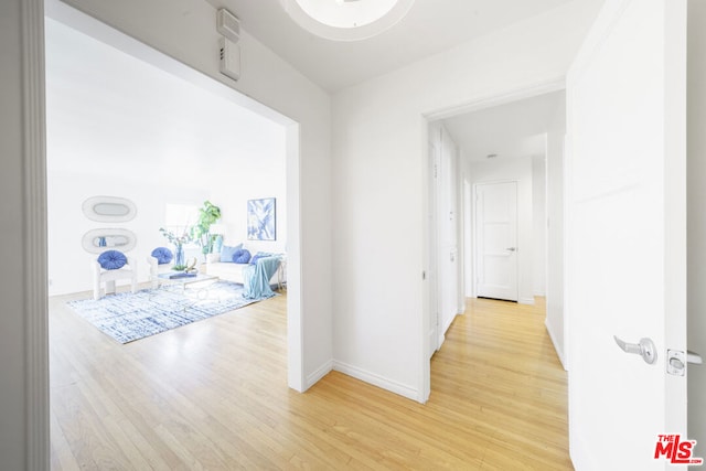 corridor with light wood-type flooring