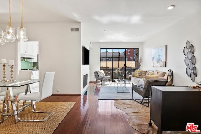 living room with dark hardwood / wood-style flooring