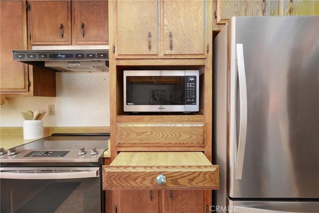 kitchen with stainless steel appliances and tile patterned flooring