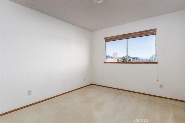 carpeted spare room with a textured ceiling