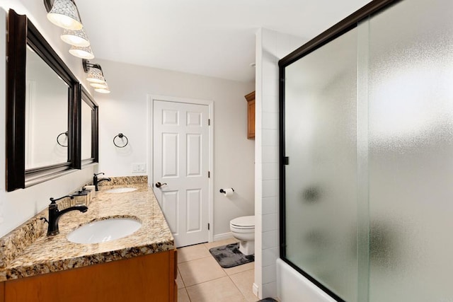 full bathroom with tile patterned flooring, enclosed tub / shower combo, vanity, and toilet