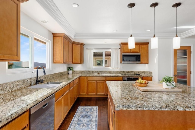 kitchen featuring a kitchen island, crown molding, appliances with stainless steel finishes, and sink