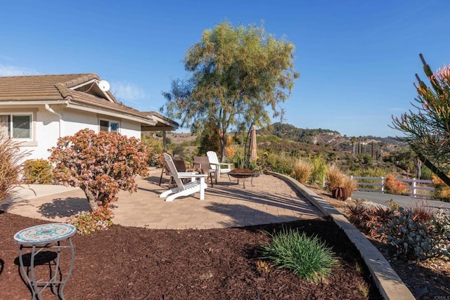 view of yard with a mountain view and a patio area