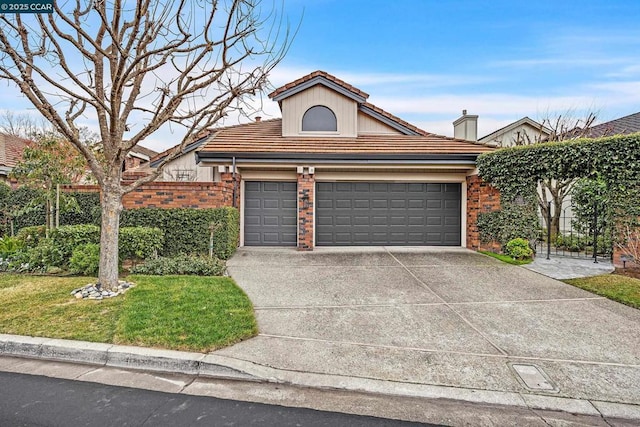 view of front facade featuring a garage and a front lawn