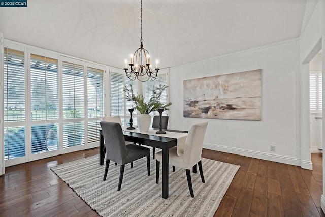 dining room with dark hardwood / wood-style flooring and a notable chandelier