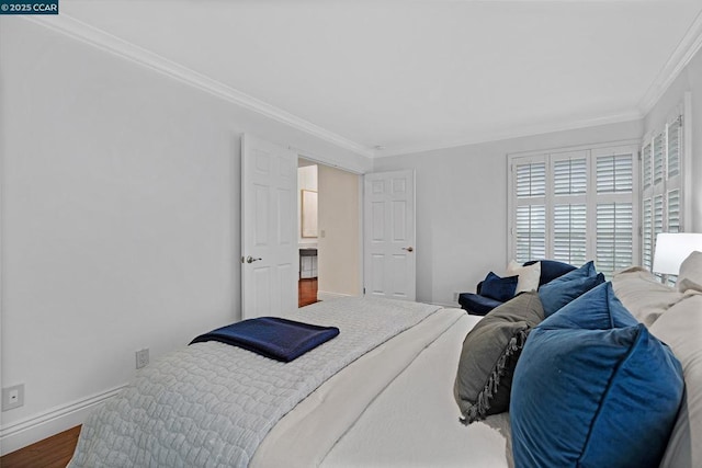 bedroom featuring crown molding and hardwood / wood-style floors