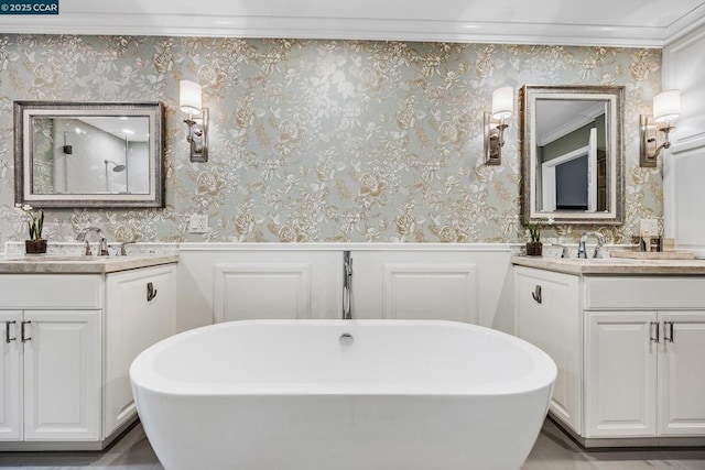 bathroom featuring crown molding, a tub to relax in, and vanity