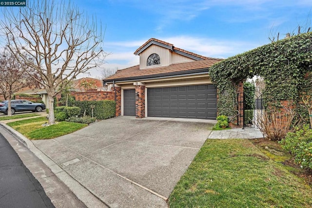 view of front of home featuring a garage and a front yard