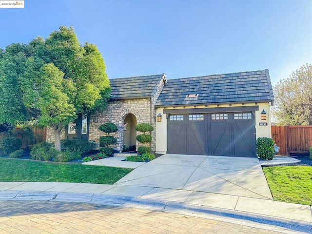 view of front of home featuring a garage and a front lawn