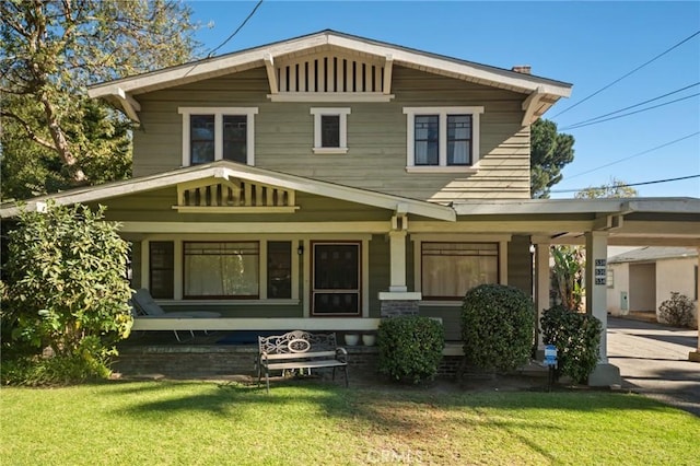 view of front of home with a porch and a front lawn