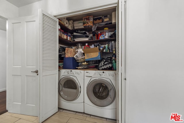 laundry area featuring washer and dryer and light tile patterned flooring