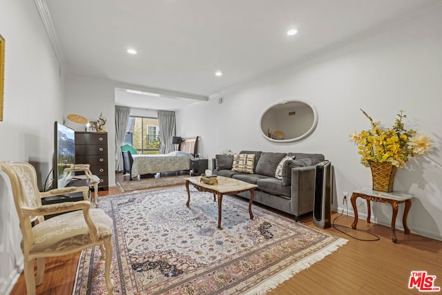 living room featuring ornamental molding and wood-type flooring