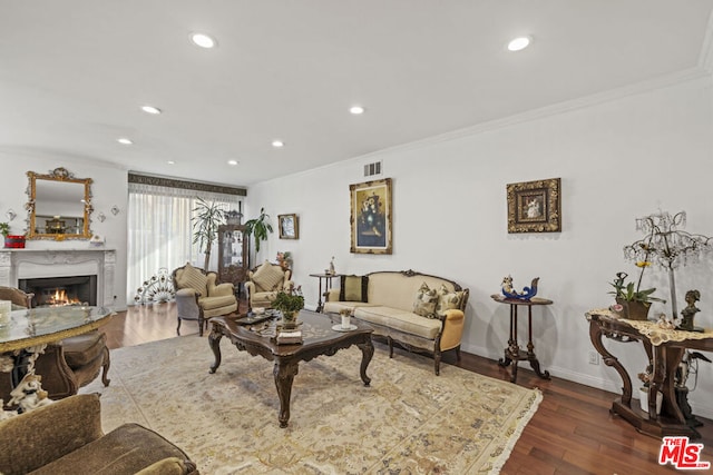 living room featuring ornamental molding and dark hardwood / wood-style flooring