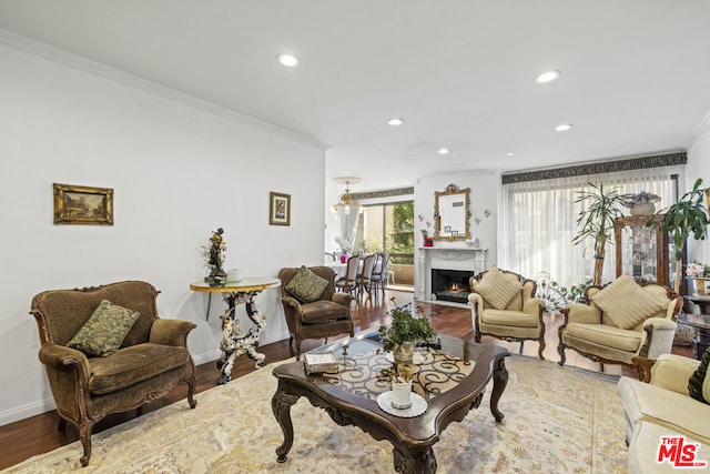 living room with hardwood / wood-style flooring and ornamental molding