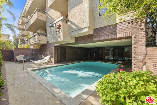 view of pool featuring a patio