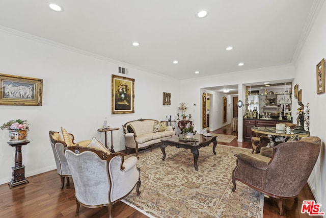 living room with crown molding and dark wood-type flooring