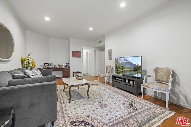 living room with crown molding and hardwood / wood-style floors