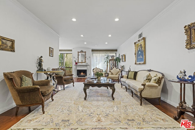 living room with dark wood-type flooring and ornamental molding