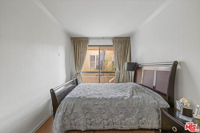 bedroom featuring hardwood / wood-style flooring and ornamental molding