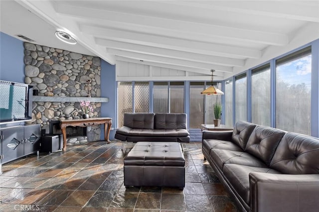 living room featuring a fireplace and vaulted ceiling with beams