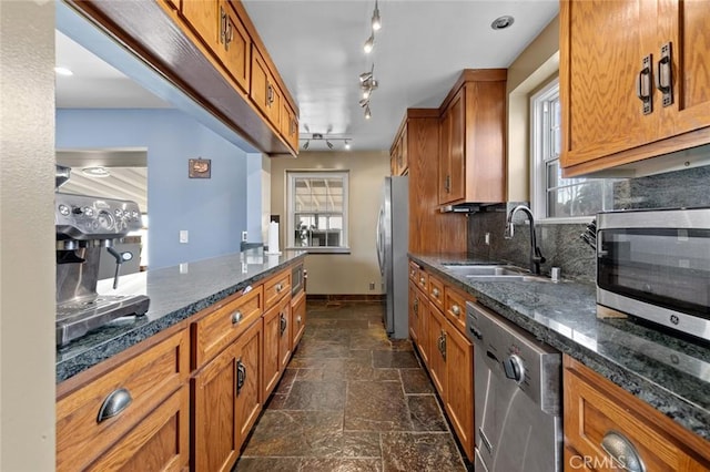 kitchen with tasteful backsplash, sink, plenty of natural light, and appliances with stainless steel finishes