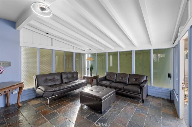 sunroom featuring vaulted ceiling with beams