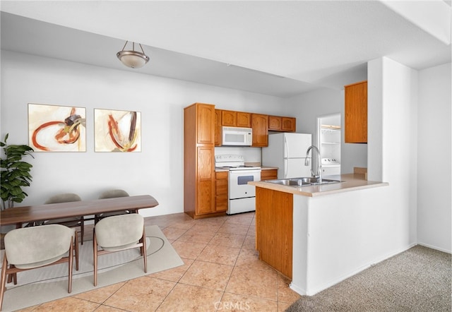 kitchen featuring sink, white appliances, kitchen peninsula, and light tile patterned floors