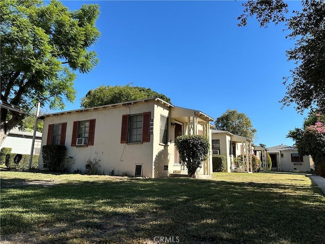 view of side of home featuring a yard and cooling unit