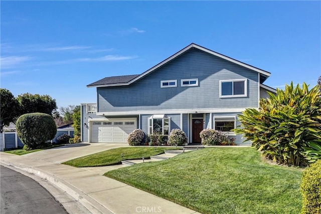 view of front property featuring a garage and a front yard