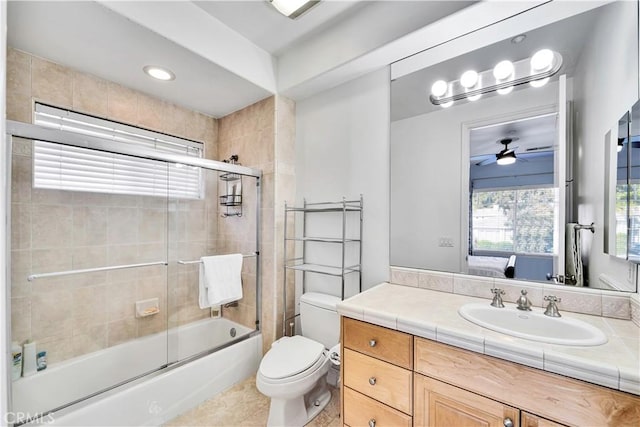 full bathroom featuring vanity, ceiling fan, enclosed tub / shower combo, and toilet