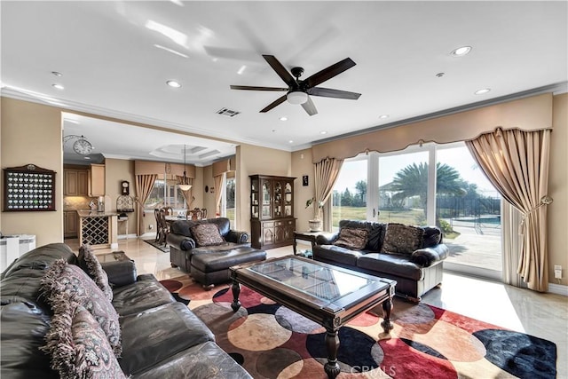 living room featuring ornamental molding and ceiling fan