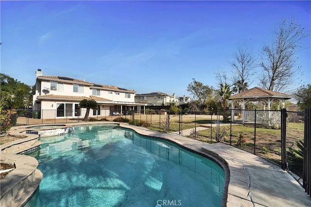 view of swimming pool with a gazebo and an in ground hot tub