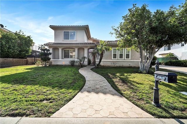 mediterranean / spanish-style home featuring a front yard and covered porch