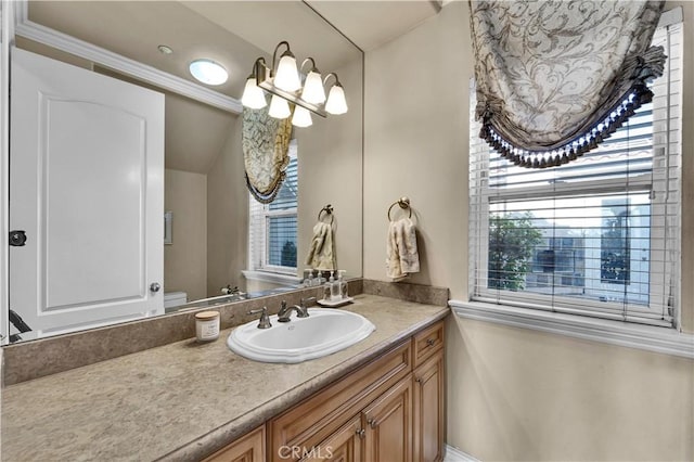 bathroom with vanity, a chandelier, and toilet