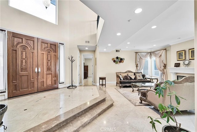 foyer featuring a high ceiling and ornamental molding