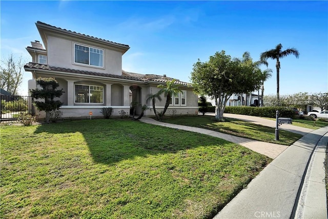 mediterranean / spanish-style home featuring a front yard