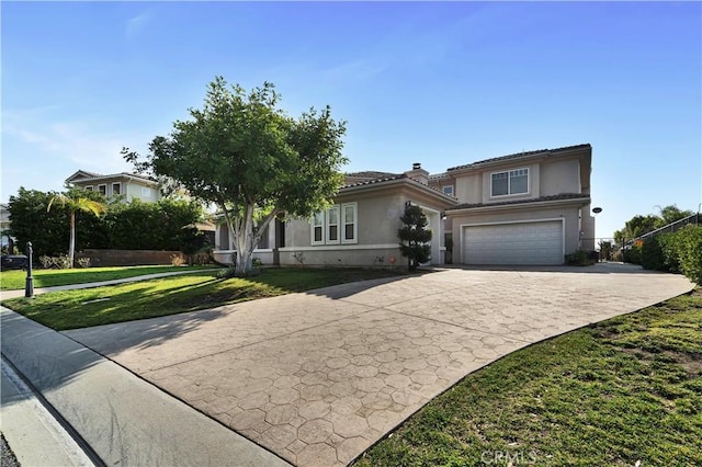 view of front of house featuring a garage and a front lawn