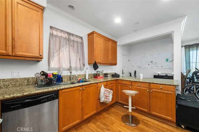 kitchen with sink, light wood-type flooring, stainless steel dishwasher, ornamental molding, and light stone countertops