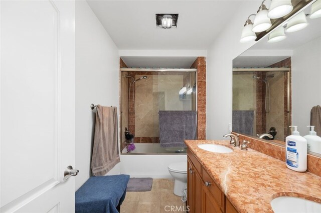 full bathroom with vanity, tile patterned floors, toilet, and combined bath / shower with glass door