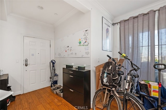 entrance foyer with crown molding and light hardwood / wood-style floors