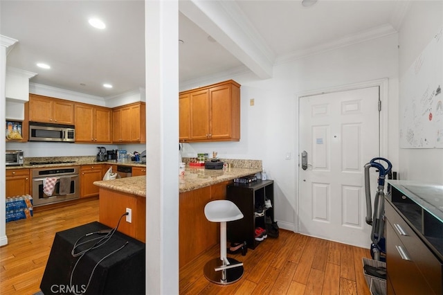 kitchen with light wood-type flooring, ornamental molding, stainless steel appliances, beam ceiling, and light stone countertops