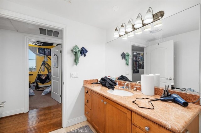 bathroom featuring hardwood / wood-style flooring and vanity