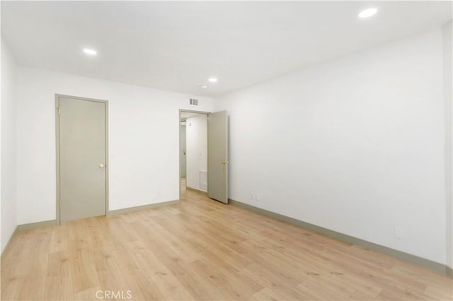 spare room featuring light wood-type flooring